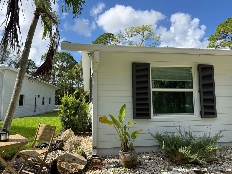 Crisp white siding and black shutters after a house wash