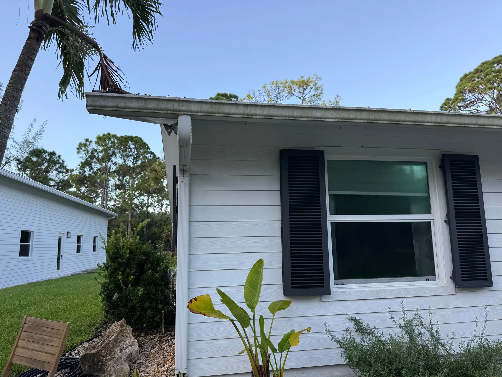 Before: dull siding with dirt and mildew buildup along the eaves