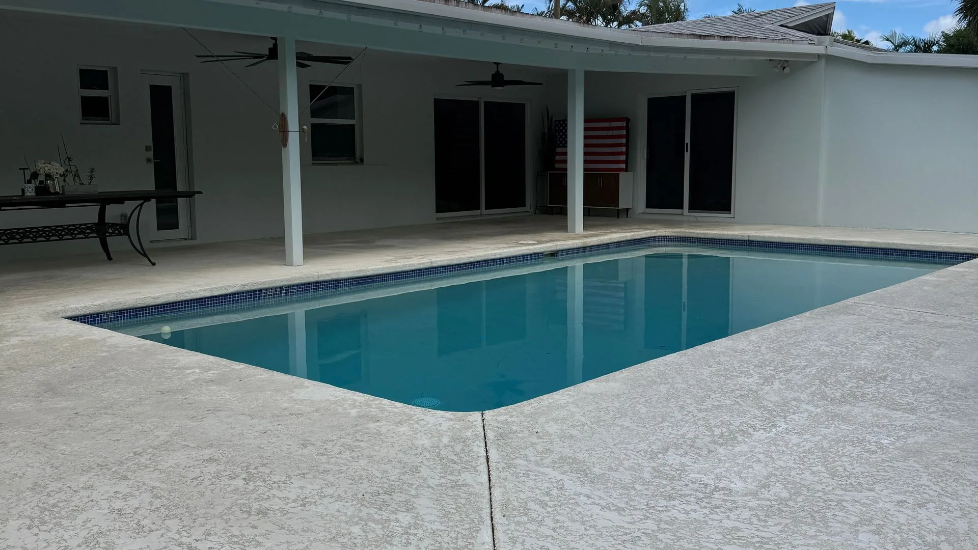 After: the pool deck cleaned bright around the water