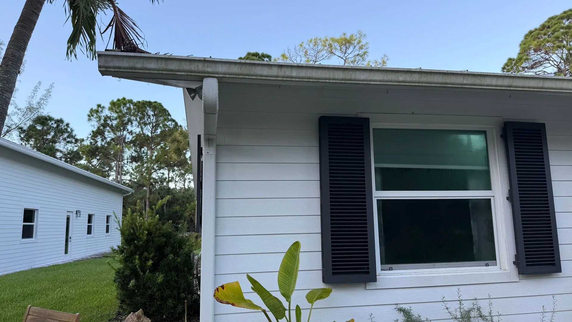 Before: dull siding with dirt and mildew buildup along the eaves