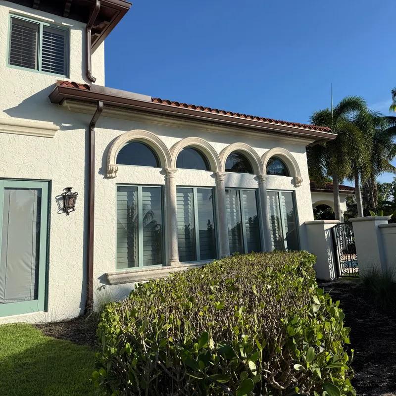 Row of clean arched windows under a barrel-tile roof